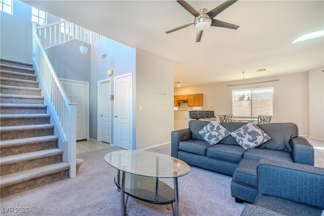 carpeted living room featuring ceiling fan