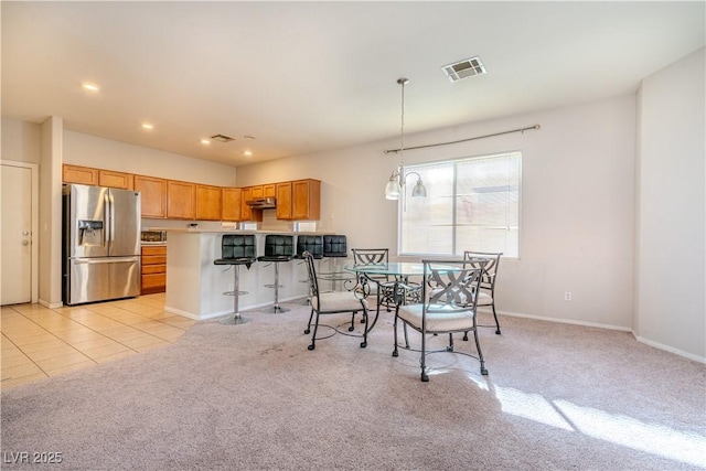 dining room featuring light carpet