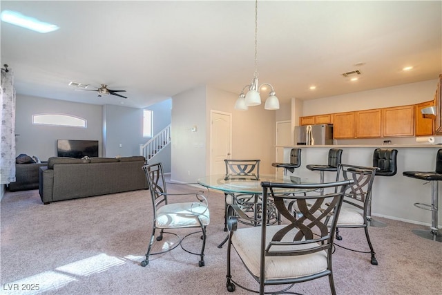 carpeted dining area featuring ceiling fan