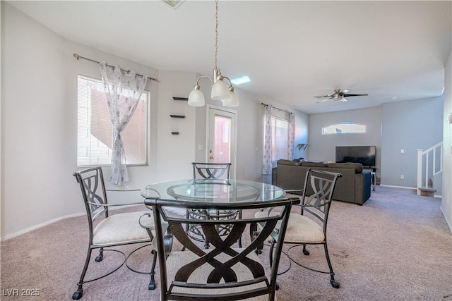 dining area featuring light carpet and ceiling fan