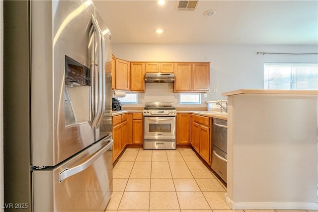 kitchen featuring light tile patterned floors, sink, and appliances with stainless steel finishes