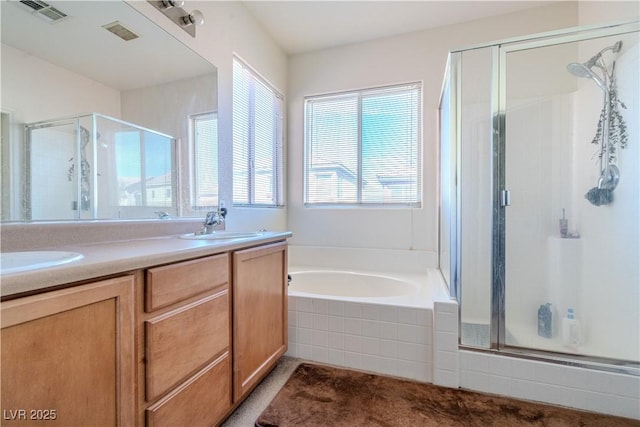 bathroom featuring vanity and separate shower and tub