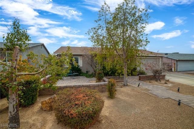 view of front of house with a garage and a patio