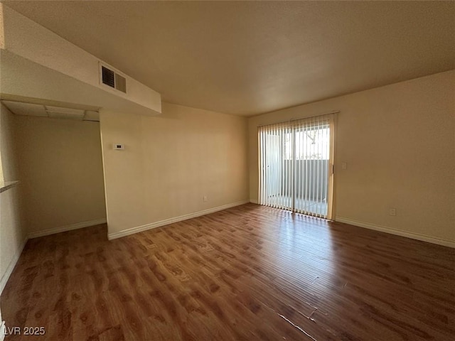 unfurnished room with dark hardwood / wood-style floors