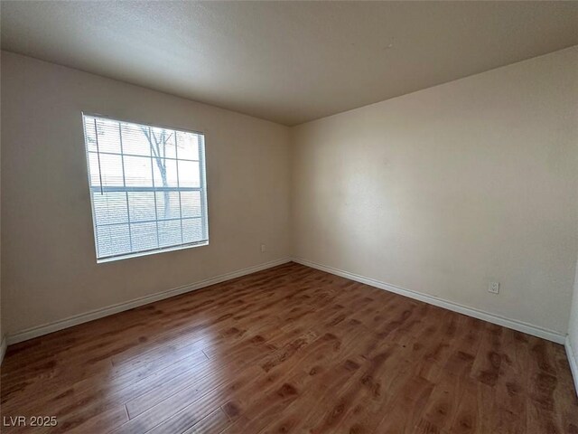 unfurnished room featuring dark wood-type flooring