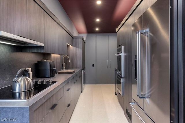 3726 Las Vegas Blvd Unit 1101, Las Vegas, NV 89158 - kitchen with stainless steel appliances, extractor fan, sink, and decorative backsplash