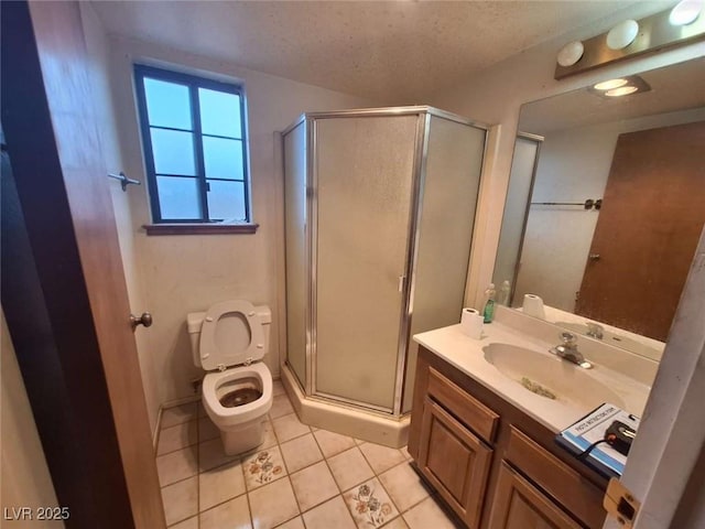 bathroom with tile patterned flooring, vanity, toilet, a shower with door, and a textured ceiling