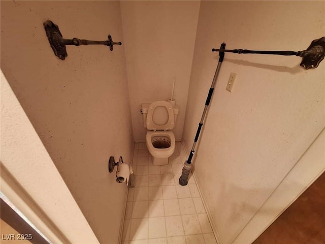 bathroom featuring toilet and tile patterned flooring