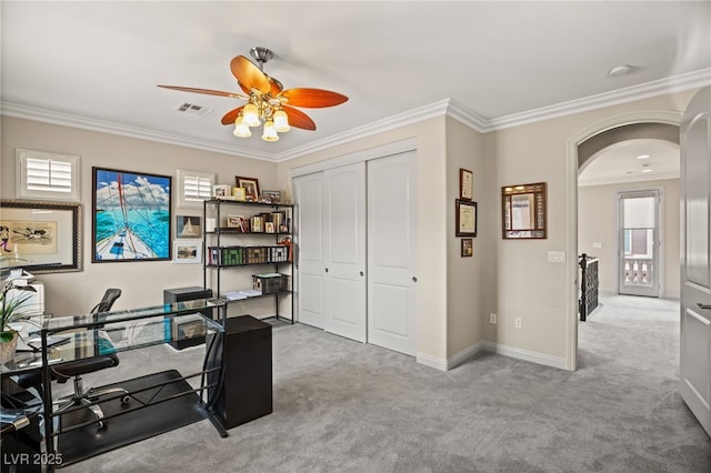 home office with crown molding, carpet, and ceiling fan