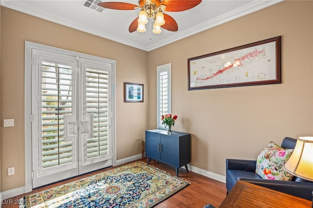 doorway featuring ceiling fan, ornamental molding, and wood-type flooring