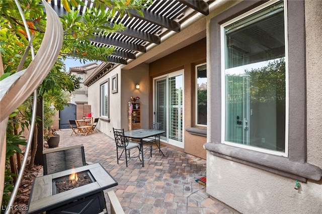 view of patio / terrace featuring an outdoor fire pit and a pergola