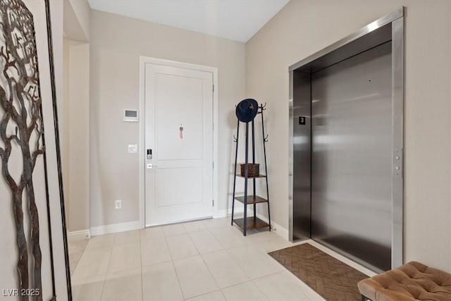 tiled foyer featuring elevator