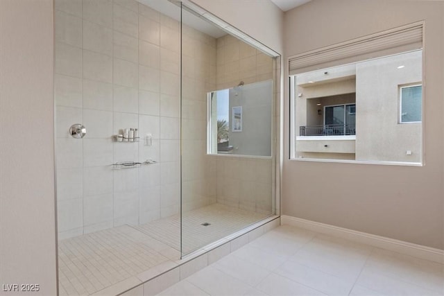 bathroom featuring tile patterned floors and a tile shower