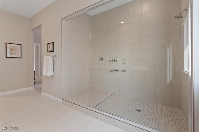 bathroom featuring tiled shower and tile patterned floors