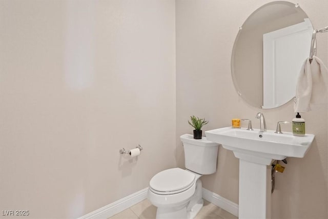 bathroom featuring tile patterned flooring and toilet