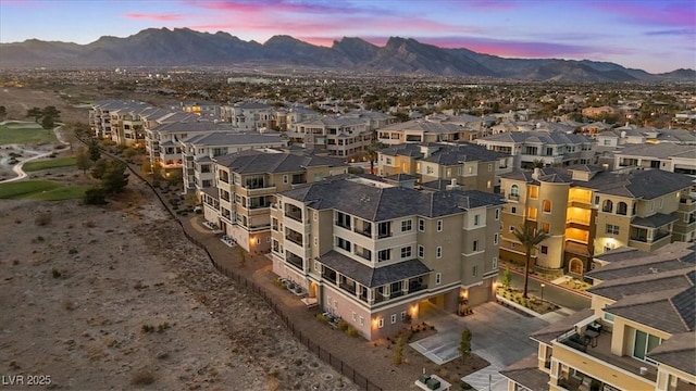 aerial view at dusk featuring a mountain view