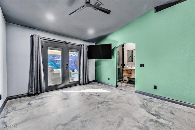 empty room featuring concrete flooring, vaulted ceiling, electric panel, ceiling fan, and french doors