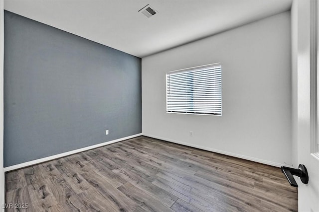 unfurnished room with hardwood / wood-style floors