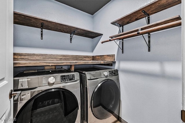 clothes washing area featuring washing machine and clothes dryer