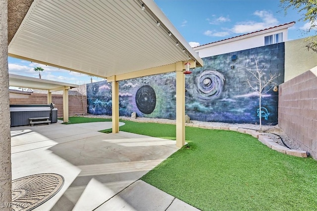 view of property's community featuring a patio, a lawn, and a jacuzzi