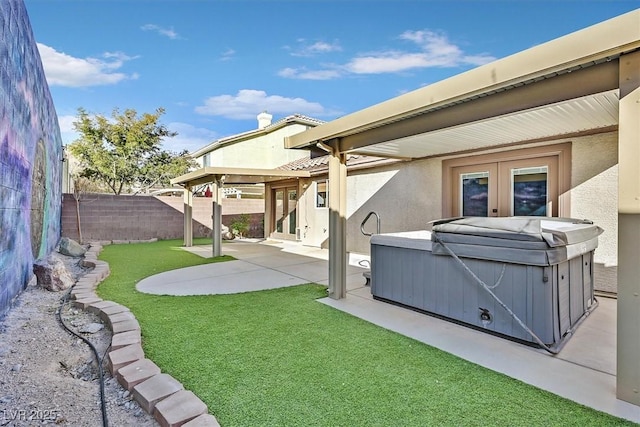 view of yard featuring french doors, a hot tub, and a patio area