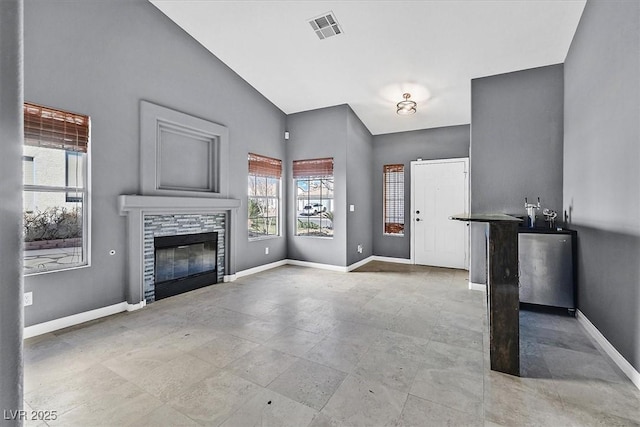 unfurnished living room featuring vaulted ceiling