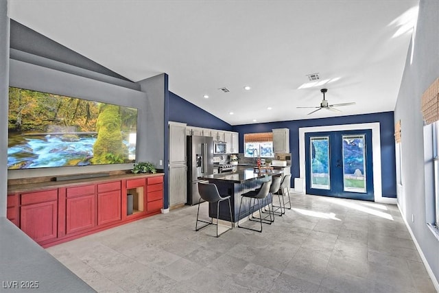 dining room featuring vaulted ceiling, ceiling fan, and french doors