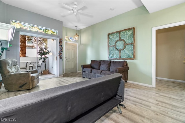 living room featuring ceiling fan and light hardwood / wood-style floors