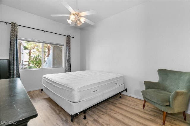 bedroom with ceiling fan and light hardwood / wood-style floors