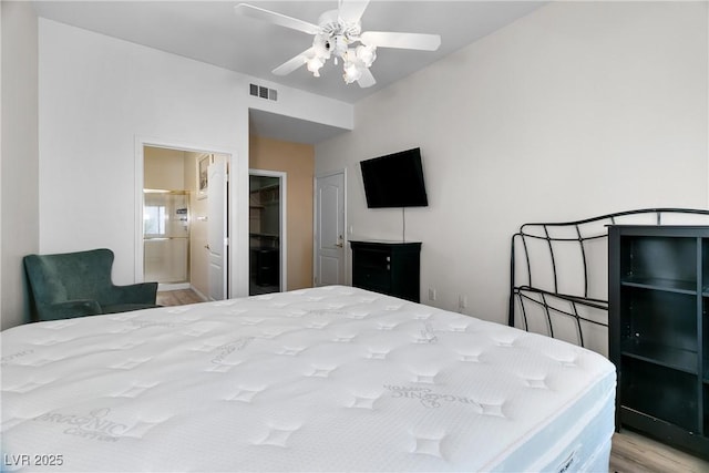 bedroom featuring ceiling fan, connected bathroom, and light wood-type flooring