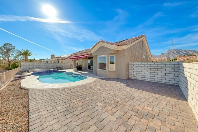 view of swimming pool with a patio, a fenced backyard, and a pool with connected hot tub