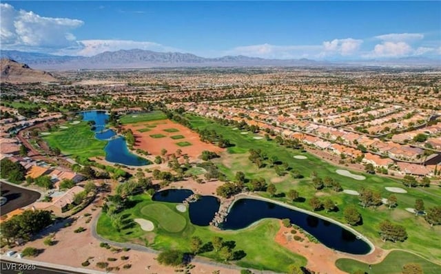 drone / aerial view featuring golf course view and a water and mountain view