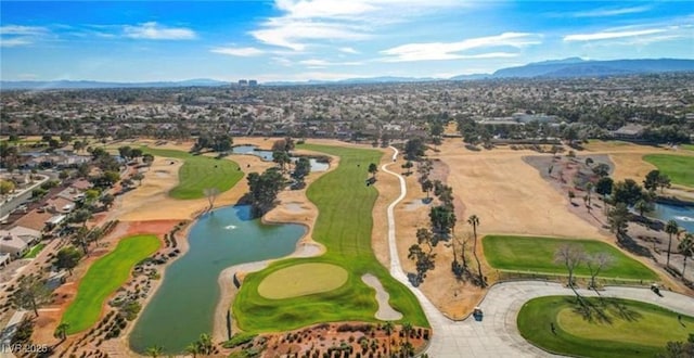 bird's eye view featuring view of golf course and a water and mountain view