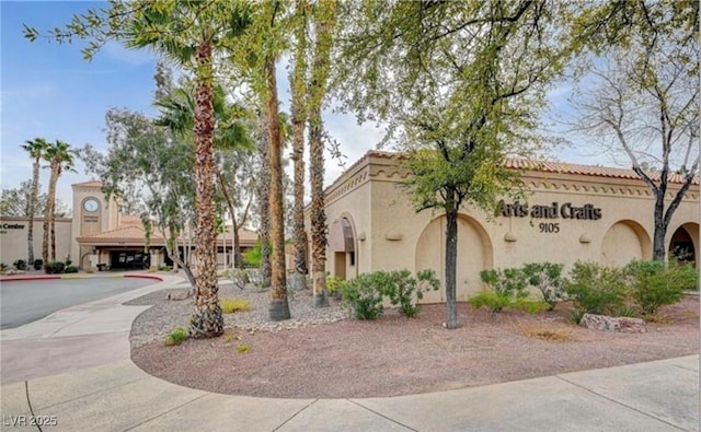 view of front of home featuring a tile roof and stucco siding