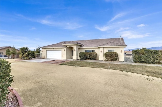 ranch-style house featuring a garage and a front yard