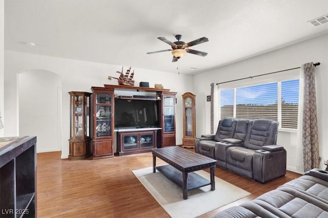 living room featuring hardwood / wood-style floors and ceiling fan