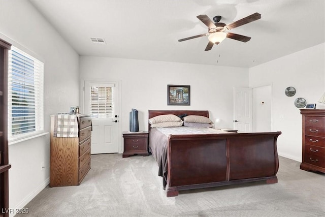 bedroom with ceiling fan and light colored carpet