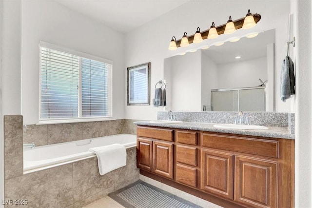 bathroom with vanity, independent shower and bath, and tile patterned flooring