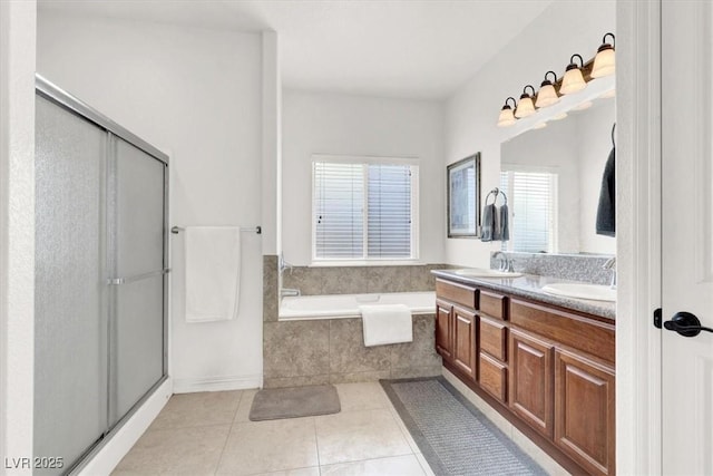 bathroom with tile patterned flooring, vanity, and separate shower and tub