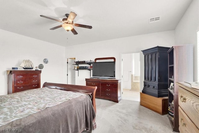 carpeted bedroom with ceiling fan and ensuite bathroom