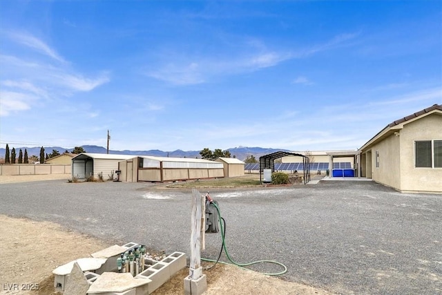 view of yard featuring a storage shed and a mountain view