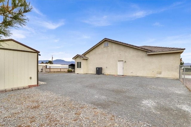 view of home's exterior featuring a mountain view and central air condition unit