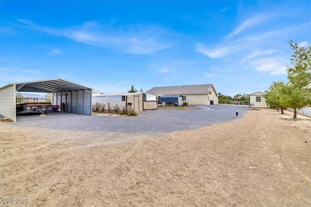 exterior space with a carport and a storage shed