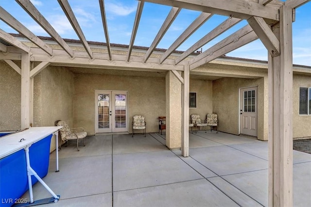 view of patio / terrace featuring a pergola and french doors