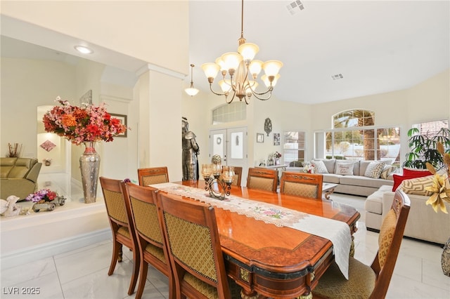 dining space featuring a notable chandelier and french doors