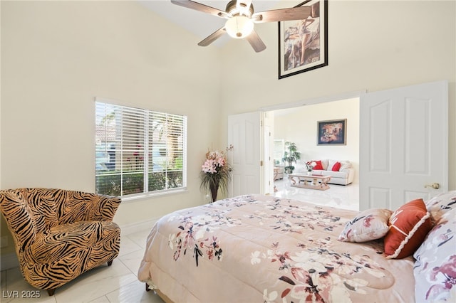 bedroom featuring a towering ceiling and ceiling fan