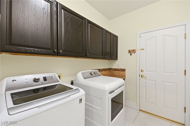 laundry area with independent washer and dryer and cabinets