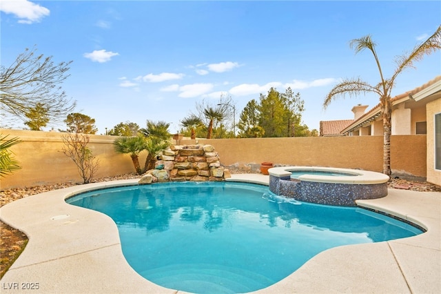 view of swimming pool with pool water feature and an in ground hot tub