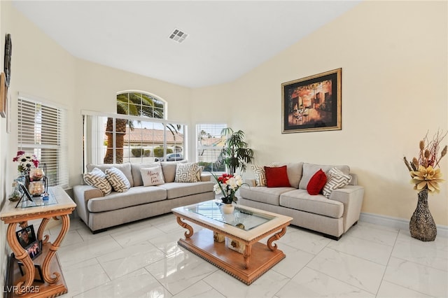 living room featuring a towering ceiling