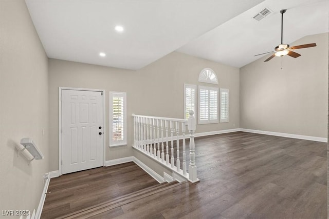 entrance foyer featuring dark wood-type flooring, ceiling fan, and vaulted ceiling